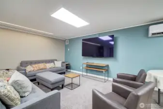 Community room has tables and chairs for parties and also this seating area for hosting an Oscar night or Super Bowl viewing.