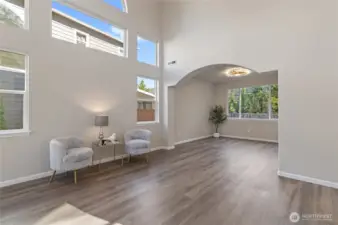 The space features large windows that extend to the ceiling, allowing for ample natural light.