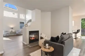 A spacious family room is situated on the opposite side of the fireplace.