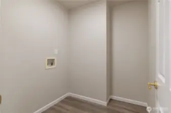 Main floor laundry room located next to garage door.