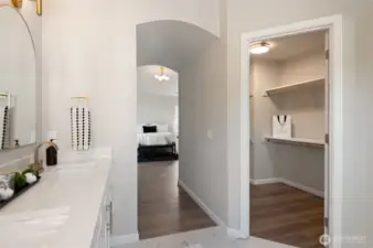 A spacious walk-in closet is featured within the primary suite, offering ample storage and organization options.