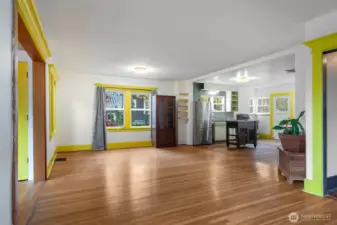 Main level: AS-IS. Existing open space, for flexible living or dining. Main entry to the left, kitchen to the right