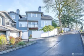 Attractive rear view of the end-unit condo with a private, fenced yard.