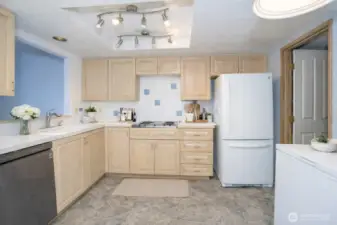Additional kitchen perspective featuring stunning cabinets and access to the utility room with a handy utility sink.