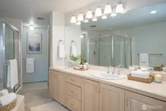 Primary ensuite featuring dual sinks, with a spacious walk-in closet conveniently located just around the corner.