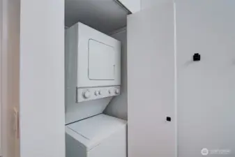 Stackable washer and dryer in the unit.