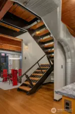 Stairs to loft level primary suite + second bedroom suite.
