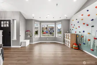 The formal living room is currently being used as a play room but offers new luxury vinyl floors and large bay window to front yard.