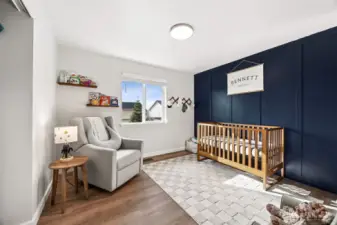 Bedroom #2 with the continual flow of the luxury vinyl planked floors and board and batten accent wall.