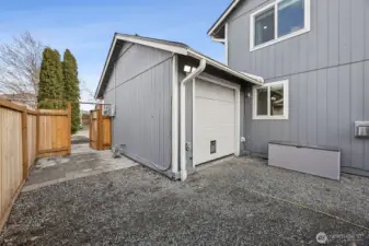 Behind the third car garage bay it opens to the backyard. Home also has a interlock for the generator.
