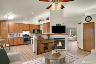 Family Room with Gas Fireplace & View to the Kitchen & Eating Nook - Virtually Staged