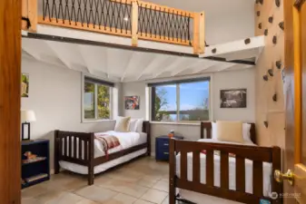 Super cool bedroom with climbing wall and loft area above.