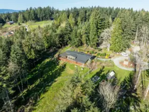 Gorgeous property with gardens, fruit trees, camping area, greenhouse, elaborate chicken coop, and useful outbuildings. A secluded but convenient hideaway for a hobby farm or just a welcoming place to call home.