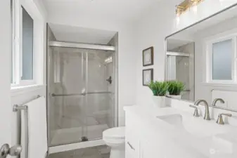 Gorgeous primary bathroom with a new shower, vanity and lighting.