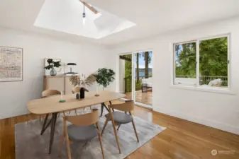 Take a peek at the water view from this skylighted dining room, with sweeping views of nature surrounding the home and large deck just steps away.