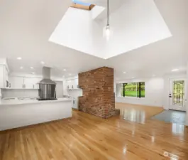 The wrap-around brick flows from the hearth in the living room into the kitchen, connecting the character of mid-century textures to create an amazing contrast with the crisp white walls and trim.