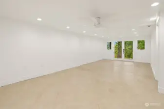 The view of the yoga rec room without virtual staging, shows that the pretty and durable tile floors with great lighting and new ceiling fan.