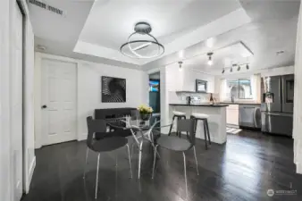 Virtually staged dining room open to kitchen