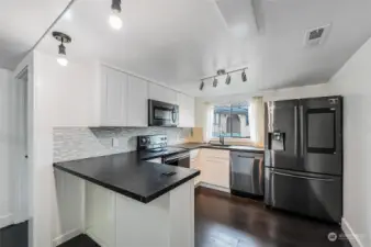 Open kitchen with stainless steel appliances