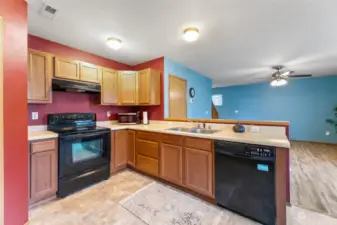 Kitchen looks out to living room and backyard