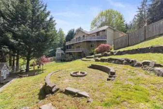 Fire pit in fully fenced backyard.