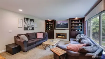 This trendy fireplace, framed by built-in shelves, adds both warmth and style to this living space