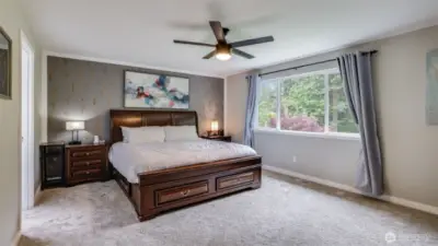 The primary suite boasts abundant natural light, generous room to relax, and private entry to the attached bathroom
