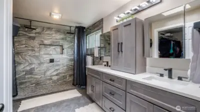 The ensuite bathroom boasts a stunning large walk-in shower with tile and quartz finishes, featuring a double-head shower for ultimate comfort. Plus, enjoy the convenience of a nearby spacious walk-in closet