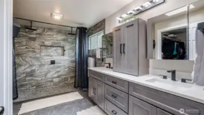 The ensuite bathroom boasts a stunning large walk-in shower with tile and quartz finishes, featuring a double-head shower for ultimate comfort. Plus, enjoy the convenience of a nearby spacious walk-in closet
