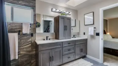 Modern en suite bathroom featuring a double vanity, ample cabinet storage, and plenty of space for your essentials