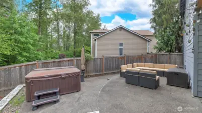 Relax and unwind—the hot tub and outdoor seating stay, with plenty of room for even more seating to enjoy the outdoors