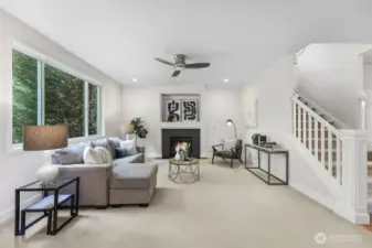 Just off the kitchen is the family room with a gas fireplace and a large window looking out to the greenbelt.