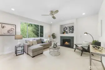 Just off the kitchen is the family room with a gas fireplace and a large window looking out to the greenbelt.