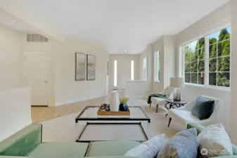 Formal living room with easy access to the dining room, garage, and entry.