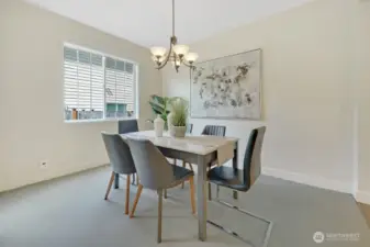 Formal dining room gets tons of natural light. The floor plan flows well from formal living to dining to family room and kitchen.