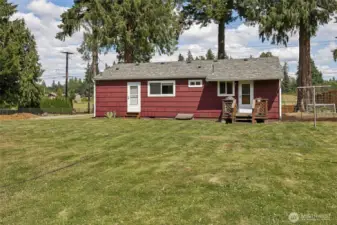 Back view of this cutie. Roof is pretty recent and in great shape. Sweet little back deck and strawberries on the side too!