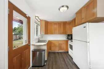 Cute little efficient kitchen with door to the back deck.