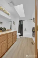 Upstairs hall bathroom with double sink vanity. New sinks, faucets, hardware, flooring  & updated tub