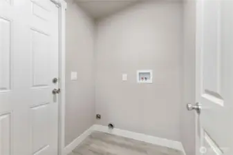 Utility room with a door that leads to the backyard