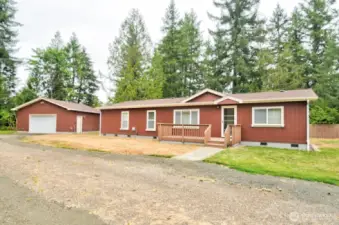 Front view of this 3 bedroom 2 bath with den home and shop