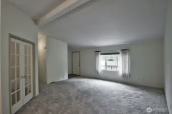 Looking from the spacious kitchen towards the living room and entry