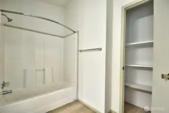 Another view of the primary bathroom with linen closet