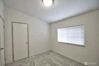 2nd bedroom with nice sized closet and view of mature trees out the window