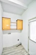 Big laundry room with  room for a freezer and a back door to the shop