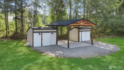 Carport flanked by sheds offering space for your storage needs.