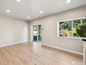 Lower level with private entrance, high ceilings, and new engineered hardwoods (LVP).