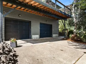 The parking area in front of the home, leads to the front door entrance at the upper right of the photo.
