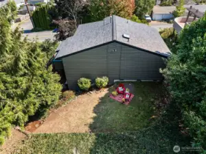 An aerial view of the backyard highlights the generous outline of the level portion of the yard and the lush privacy landscaping.