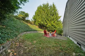 The large backyard with terraced slopes, enjoys plenty of privacy, yet includes a tiered level, next to the home, with retaining wall.  Garden, play or retreat here.