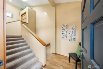 Come on in! The rich wood entry level of the home greats guests and offers an attached shoe cupboard (not seen in photo).Head up to the great room or down to the huge garage and crawl space.